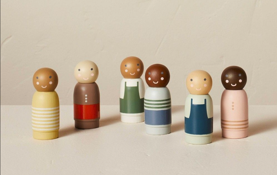Wooden Montessori peg dolls in varied colors symbolizing diversity and family connection.